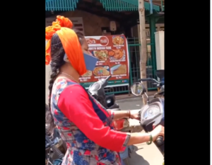 Bengaluru Woman’s Unusual Phone Use While Riding Scooter Sparks Controversy